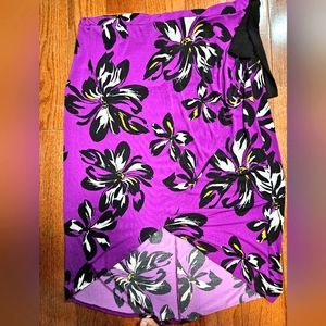 Purple, black, yellow and white floral plus size skirt with black bow on waist.